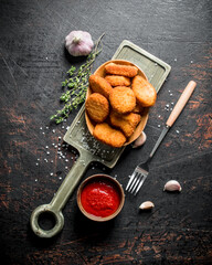 Wall Mural - Chicken nuggets with garlic, tomato sauce and thyme.