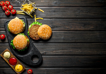 Wall Mural - Burgers with fries, sauces and cherry.