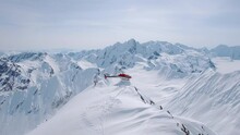 Heli-Skiing Helicopter Take-off From A Snowy Mountain In Alaska