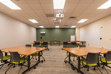 Wall Mural - Interior of an office training, meeting, conference room with desks, chairs, and white board.  Nobody included in image.