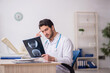 © Elnur - Young male doctor radiologist working in the clinic