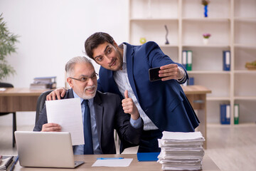 Two male colleagues working in the office