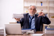 © Elnur - Old male employee and too much work in the office