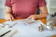 © Charlie's - Saving money for Real estate investment with stack of money coins for buy home and loan for prepare in future financial insurance. Accountant verify growing business concept.