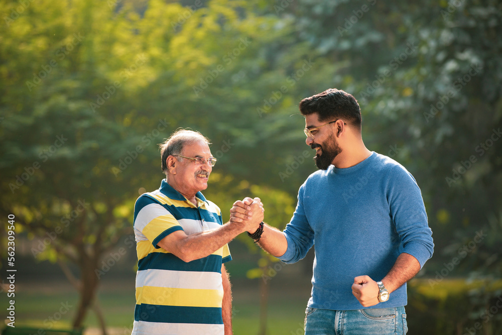 Old indian father with his young son spending time at park. Stock Photo | Adobe Stock