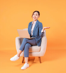 Wall Mural - Photo of young Asian businesswoman sitting on armchair