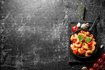 Sticker - Pasta in pan on a cutting Board with garlic,tomato and mint leaves.