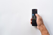 © Mulad Images - Hand holding television remote control isolated on white background