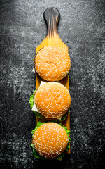 Sticker - Burgers on a wooden stand.