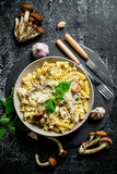 Fototapeta Kuchnia - Fusilli pasta in a bowl of mushrooms and garlic.