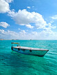 Simple fishing boat in the transparent sea