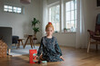 © Cavan Images - young girl playing silly games at home with toy coffee machine