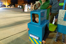Child In Homemade Robot Costume Stands In Line For Trick-or-treating