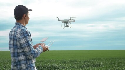 Sticker - smart farming tech agriculture farming. man farmer engineer studies a wheat crop in a green field using a technology quadcopter. male red worker neck works in a green in lifestyle a field of corn