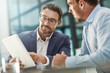 © Reese/peopleimages.com - Tablet, teamwork and meeting of business people in office discussion. Collaboration, technology and men or employees with touchscreen planning sales, marketing or advertising strategy in company.