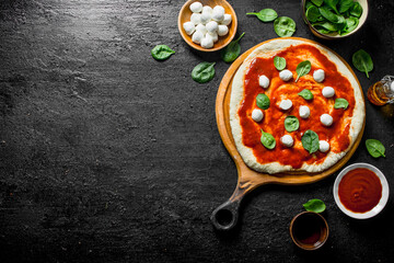 Sticker - Preparation pizza. Rolled out dough with tomato paste, spinach and mozzarella.