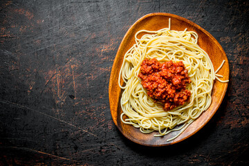 Sticker - Pasta spaghetti with Bolognese sauce in a wooden bowl.