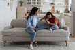 © DimaBerlin - Loving mother sitting with sad daughter on sofa at home, helping child to cope with friendship breakup. Disappointed teen girl looking at phone screen, sharing feelings with mom. First love concept