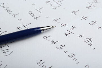 Wall Mural - Sheet of paper with different mathematical formulas and pen, closeup
