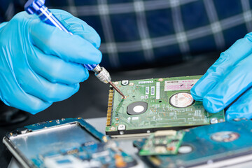 Wall Mural - Technician repairing inside of mobile phone by soldering iron. Integrated Circuit. the concept of data, hardware, technology.