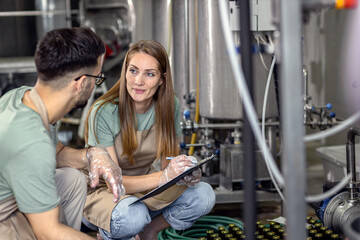 Man and woman working in craft brewery.