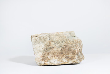 Wall Mural - podium pedestal made of natural sand stone isolated on white background with hard shadows. minimal e
