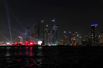 Wall Mural - Beautiful night view of Dubai skyscrapers from the sea. skyline of Dubai Marina after sunset with a sea in the foreground