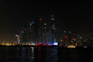 Wall Mural - City at night, panoramic scene of downtown reflected Dubai