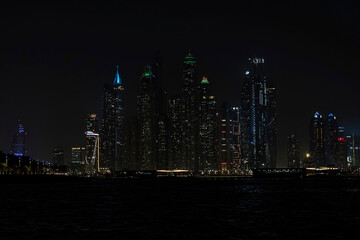 Wall Mural - Beautiful night view of Dubai skyscrapers from the sea. skyline of Dubai Marina after sunset with a sea in the foreground