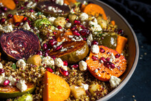 Close Up Of Warm Autumn Quinoa Salad With Figs, Feta Cheese, Pomegranate, And Baked Veggies Sweet Potato, Brussels Sprouts. Generative AI
