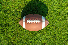 Rugby Ball On A Patch Of Grass. A National Sport In The United States Of America. Top View,
