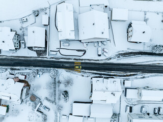 Canvas Print - Aerial view of town with snow covered houses. Roof tops with snow on residential buildings in Switzerland.