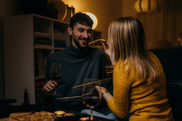 Canvas Print - A woman is feeding her boyfriend pizza