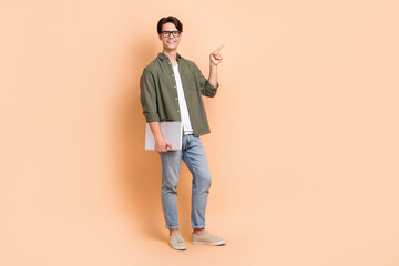 Canvas Print - Full length size cadre of young cheerful positive man remote education direct finger point mockup with laptop isolated on beige color background