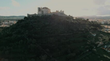 Poster - The Sanctuary of San Salvador located on top of hill overlooking the town of Artá, drone point of view during sunny day. Spanish Balearic island of Majorca. Travel destinations and tourism concept 
