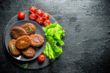 Sticker - Cutlets with cherry tomatoes and salad leaves.