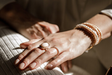 Wall Mural - Close up picture of womans hand with gold jewelry.