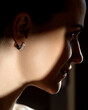 Fefashionable portrait of a girl in long diamond earrings.