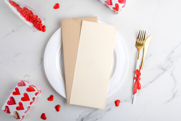 Poster - Vertical menu card mockup with festive Valentines day, wedding or birthday table setting, ceramic plate, red hearts, gifts on white marble background. Empty blank card mock up. Restaurant menu concept