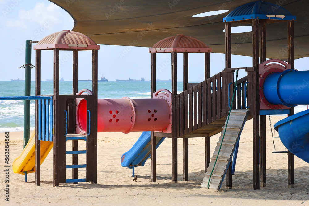 Children's playground with slide on beach