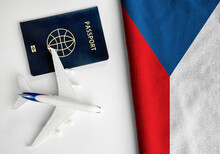 Flag of Czechia with passport and toy airplane. Flight travel concept 