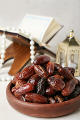 Wall Mural - Bowl with dried dates for Ramadan on light table, closeup