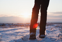 Men's Feet In Boots In The Snow Walking In Winter