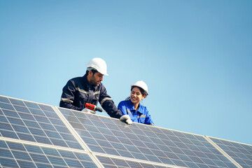 Engineer and Female Apprentice Working Together On Solar Farm Installation.