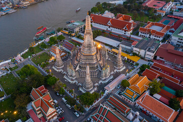 Aerial view Day to Night of Chao Phraya River with Royal Grand Palace and Emerald Buddha Temple Landmark of Bangkok, Thailand. Amazing Drone Footage over the City skyline in twilight.