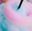 Close up of pink and blue cotton candy created using generative ai technology