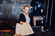 © Dusan Petkovic - A receptionist is giving papers to a customer while standing at reception.