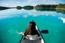High Angle View Of Woman In Boat And Turquoise Water In Lake, British Columbia, Canada