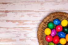 Tabletop Easter Theme With Copy Space. Colorful Easter Eggs With Basket 