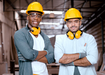 Two male carpenters work in carpentry workshop. Diverse ethnic men at work in wood furniture building factory. Multiracial joiner man and craftsman worker standing together in woodwork manufacturing.